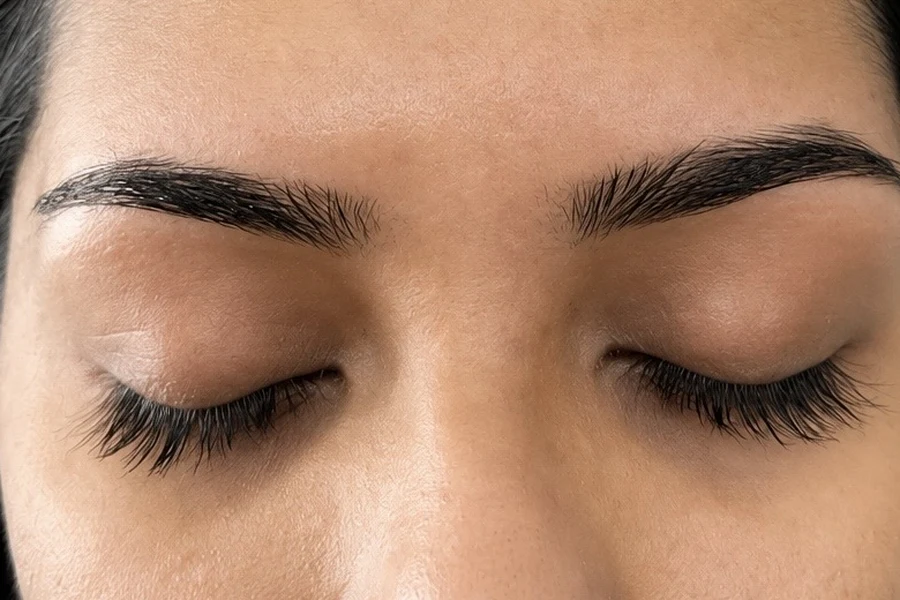 A client's naturally shaped eyebrows after threading at Allure Salon